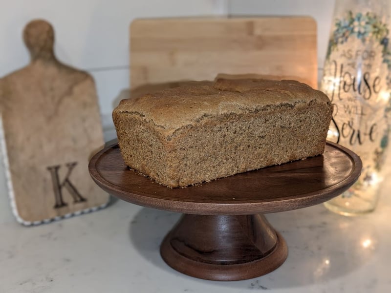 A loaf of bread on a wooden pedestal.