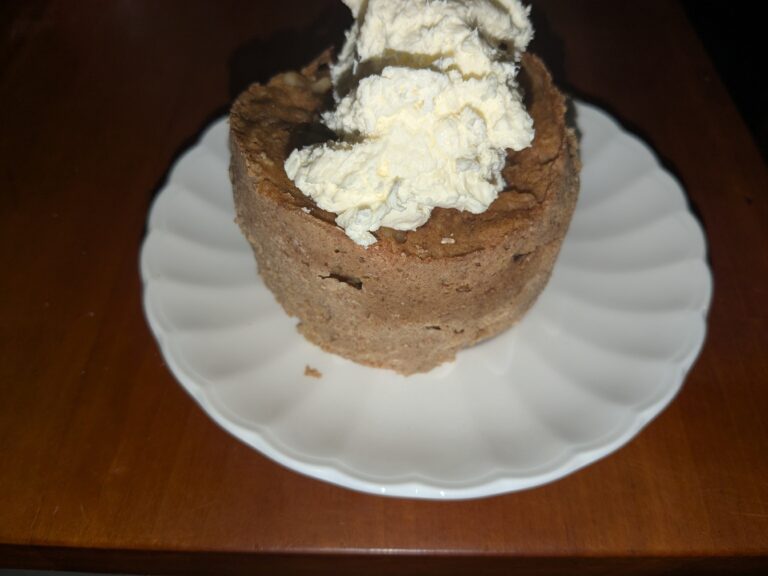Carrot mug cake with icing on a plate